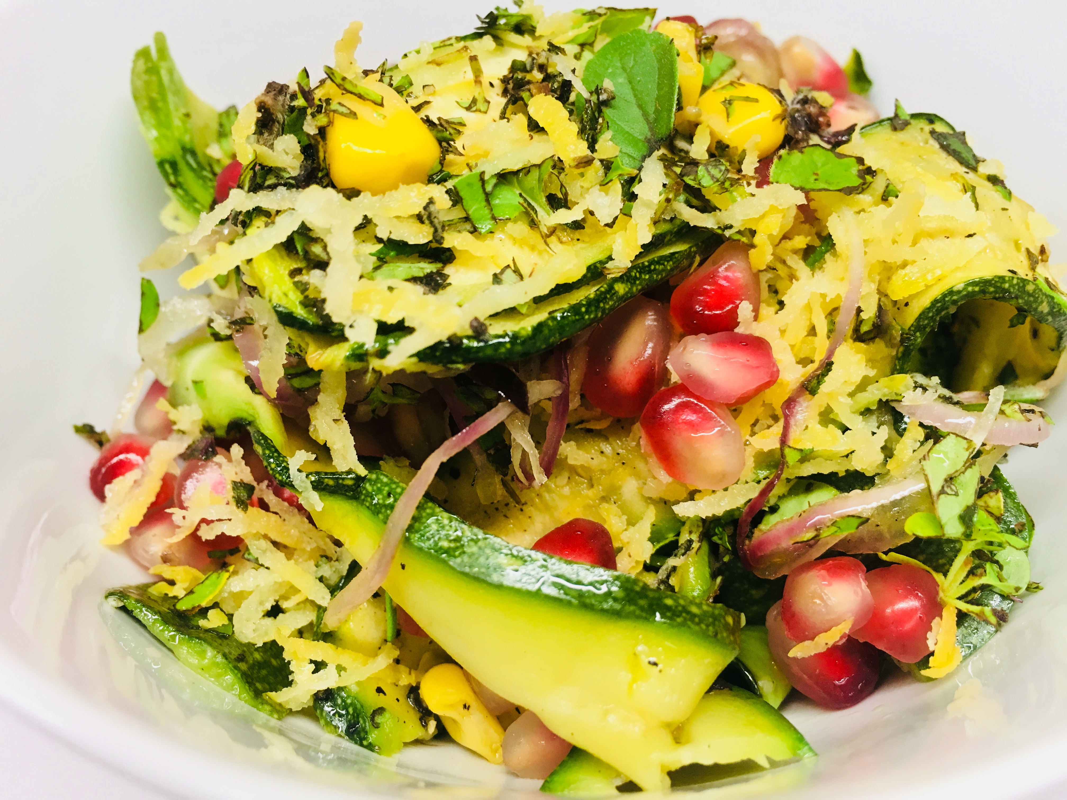 Geröstete Zucchini mit Mais, roten Zwiebeln und Granatapfelkernen